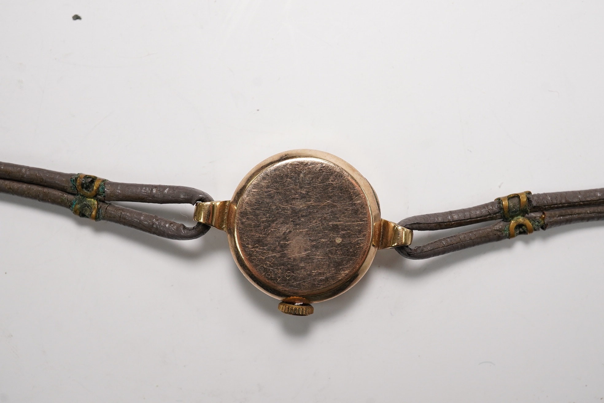 A lady's 9ct gold Rolex manual wind wrist watch, with Arabic dial and subsidiary seconds, case back numbered 22110, case diameter 21mm, on an associated twin strand fabric strap. Condition - poor to fair